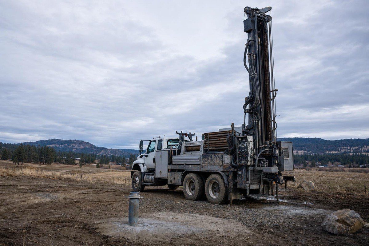 Water well drilling rig and freshly capped wellhead on a rural Spokane County, WA property